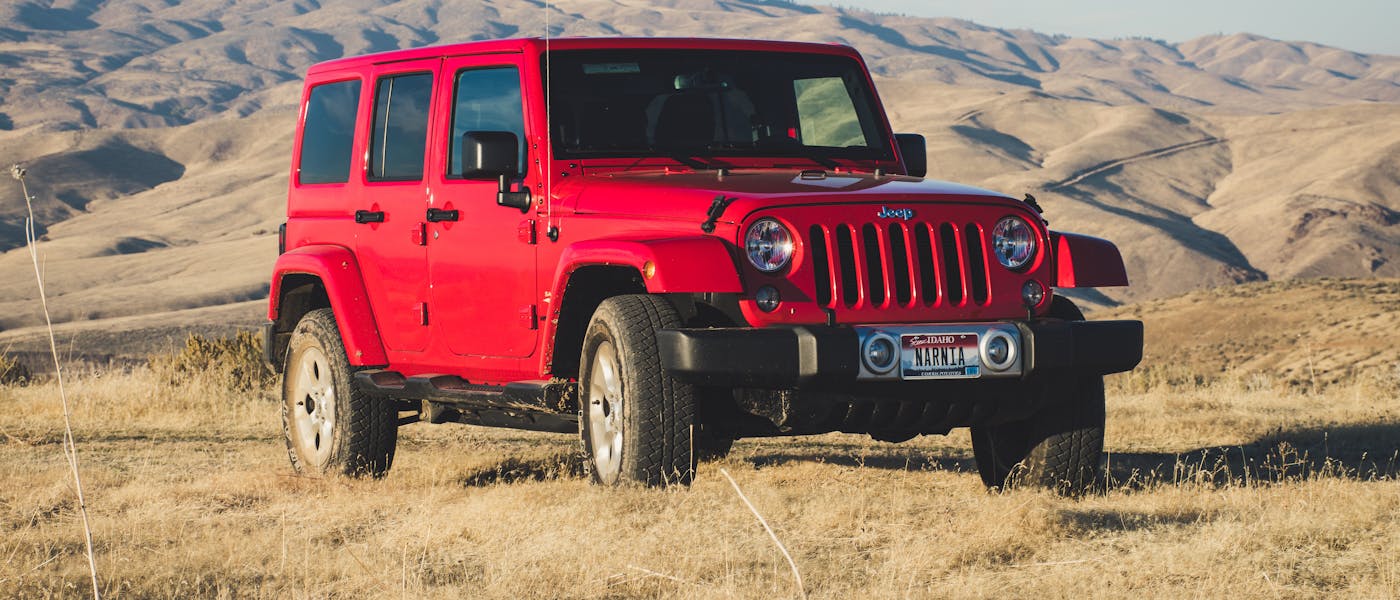 Red Jeep Wrangler SUV outdoors