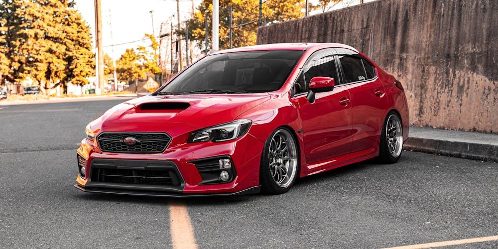 Red Subaru sedan on the road